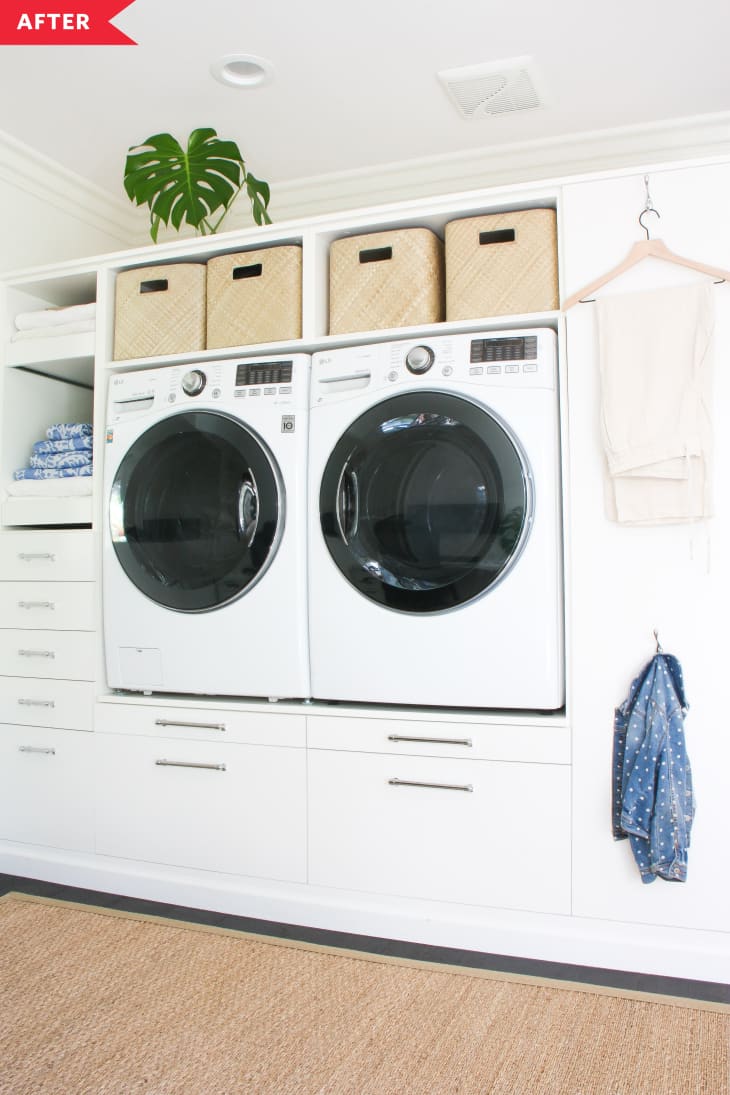 After: White laundry wall with raised washer and dryer and storage