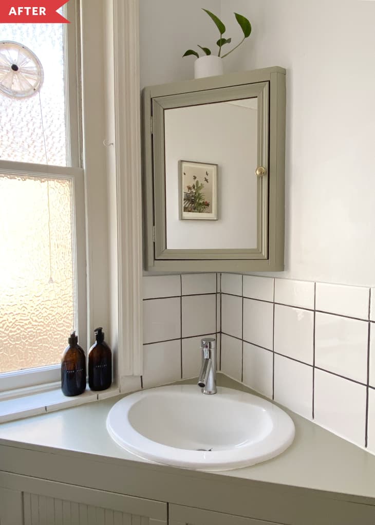 After: Bathroom with light green tub surround, white tile, and light gray walls