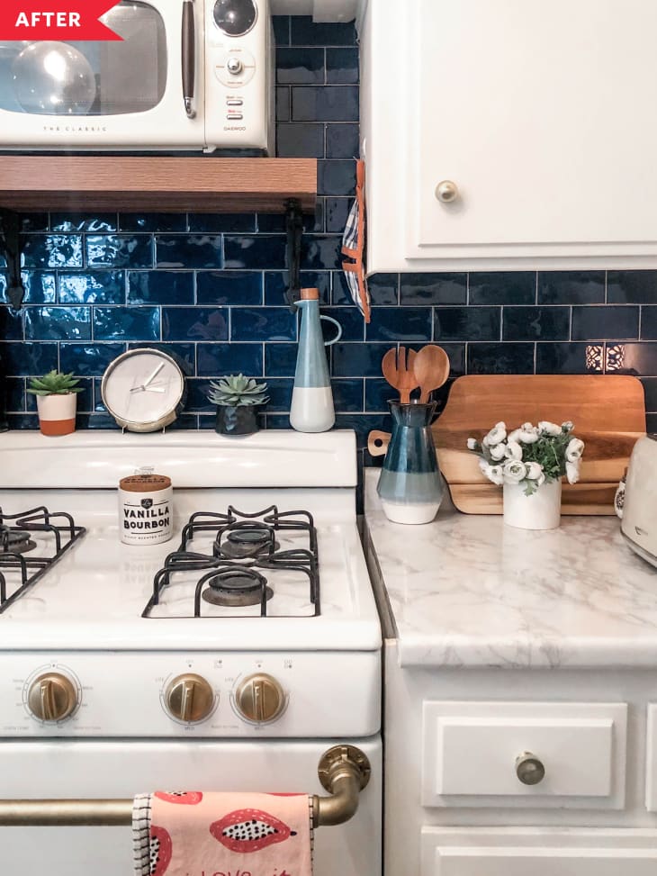 After: Kitchen with white cabinets, faux marble counters, blue stick-on backsplash