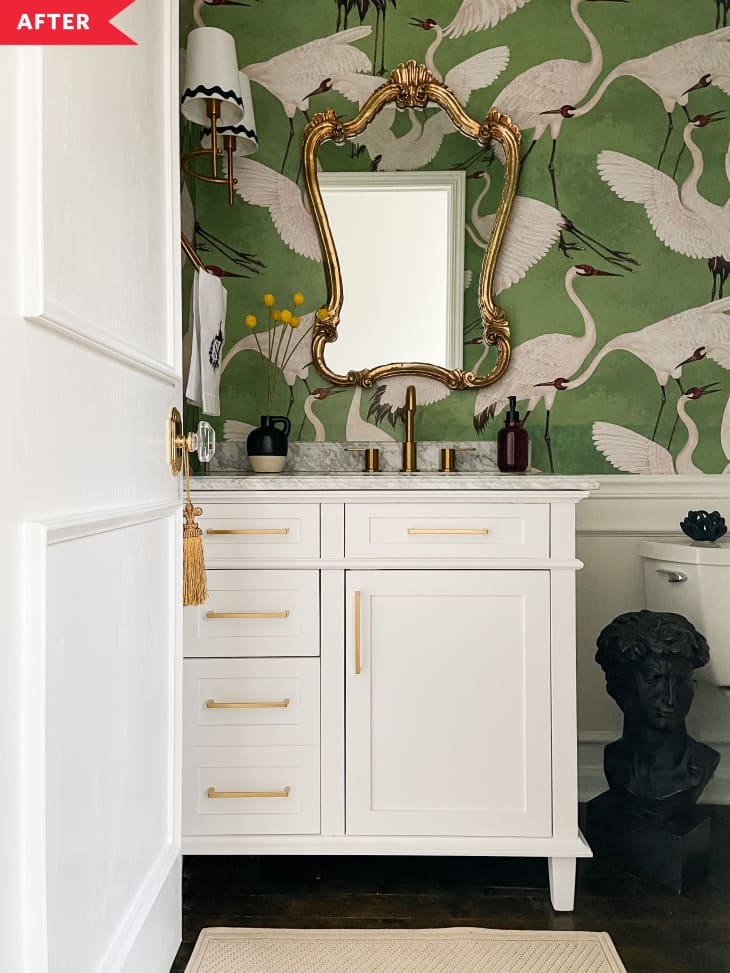 After: Bathroom with crane wallpaper and picture frame wainscoting, plus white vanity and gold mirror
