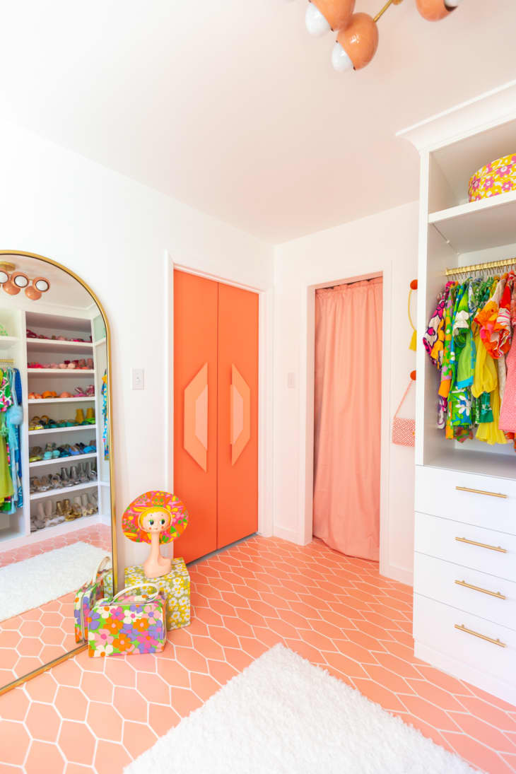 bedroom with orange floor and matching orange closet doors featuring laser-cut wood handles