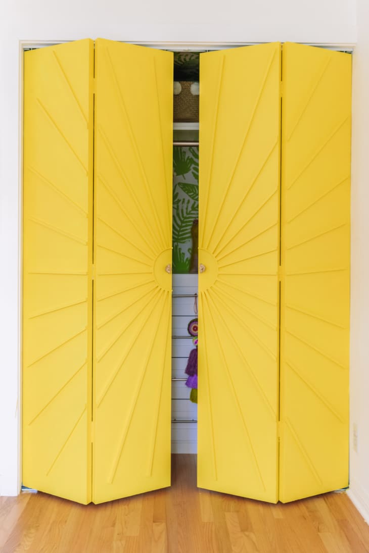 yellow closet doors with wood overlay in sunburst pattern