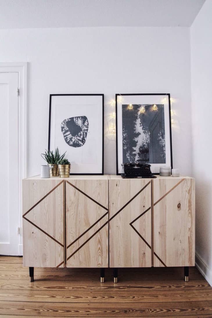 Black and white photos above wooden IVAR cabinets with metallic tape