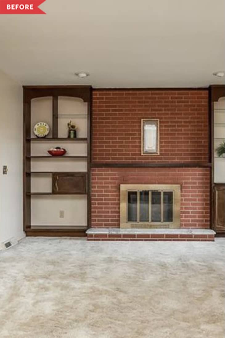 Before: red brick fireplace with wood shelving on the sides and a brass fireplace insert