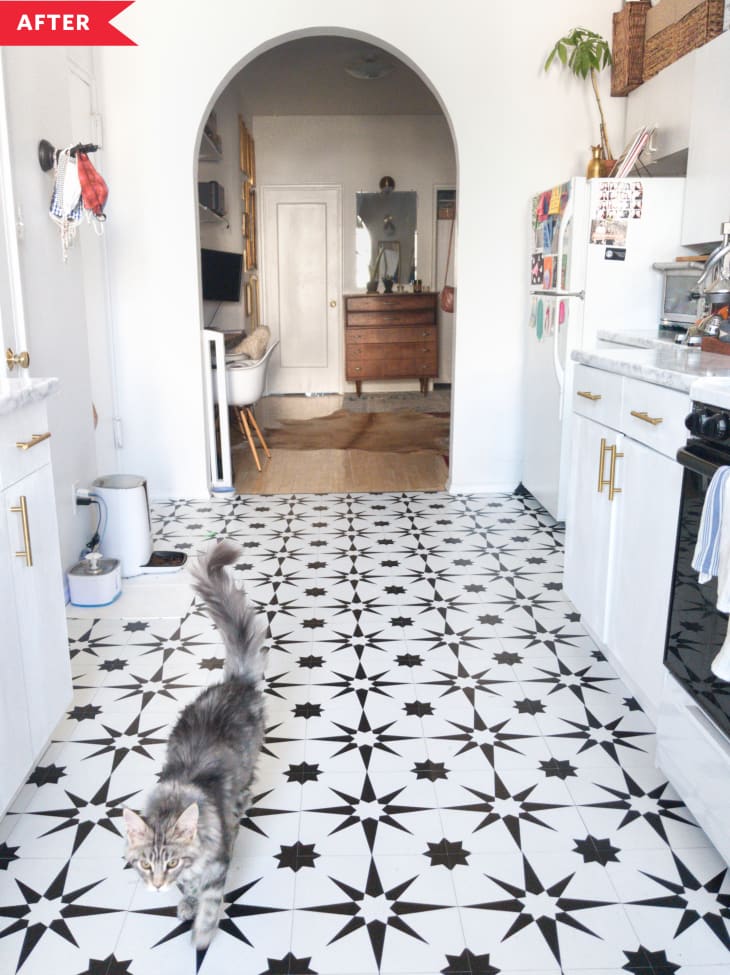 After: Kitchen with white cabinets, faux marble counters, and black and white floor