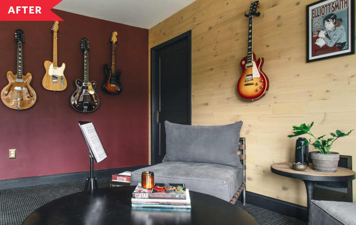 After: living area with one red wall, one wood accent wall, and guitars on display, plus two cozy chairs around a coffee table.