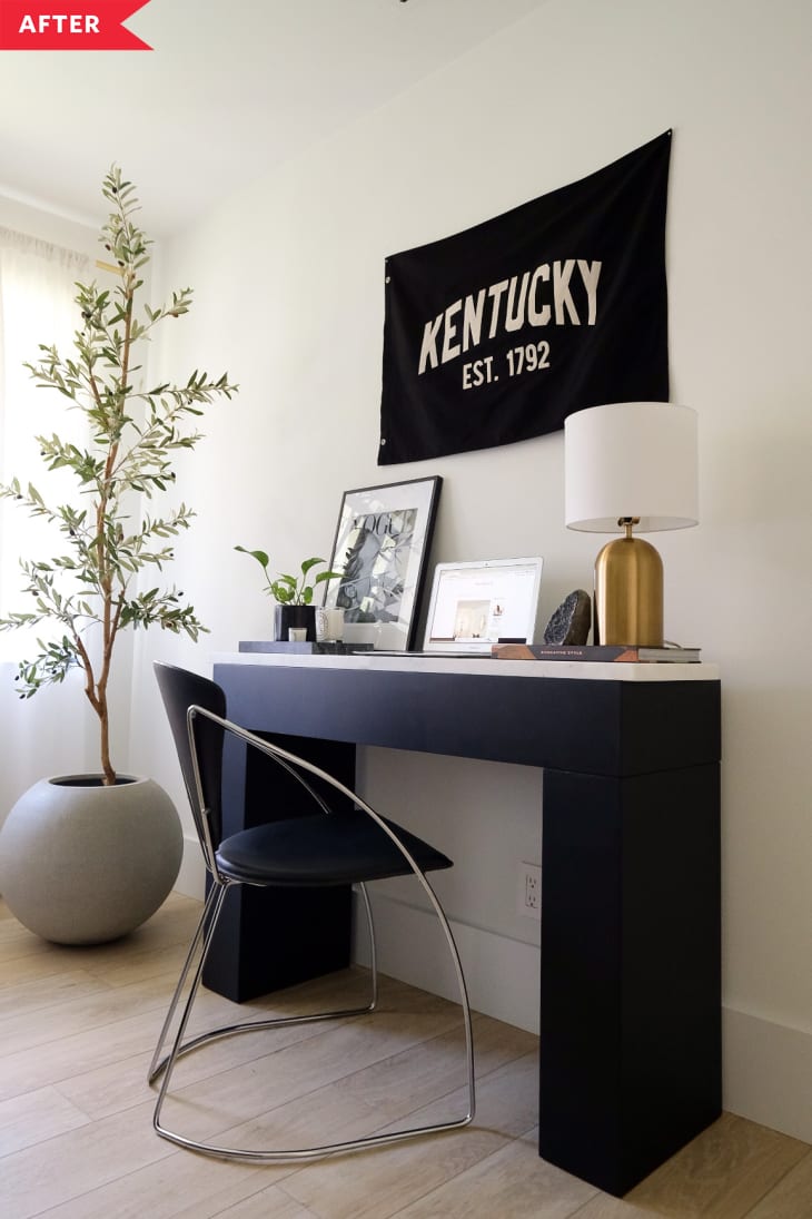 After: black desk with marble top against a white wall with decor