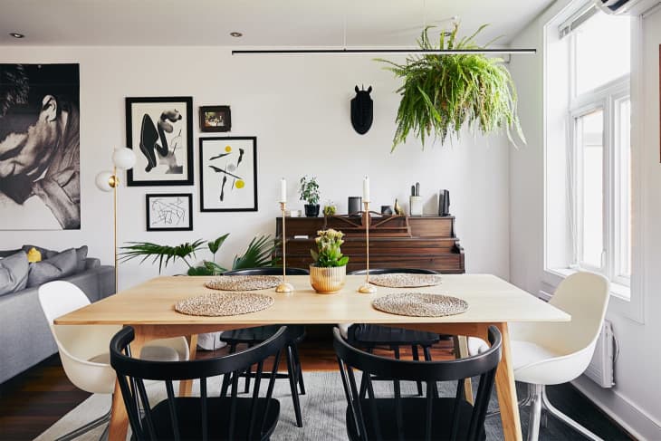 Dining room with white walls and mismatched chairs at table