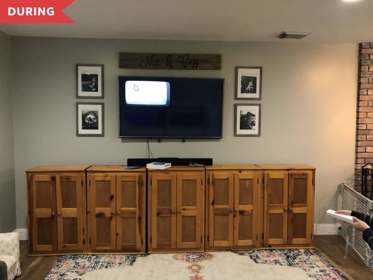 During: Family room with wood kitchen cabinets lined up under tv