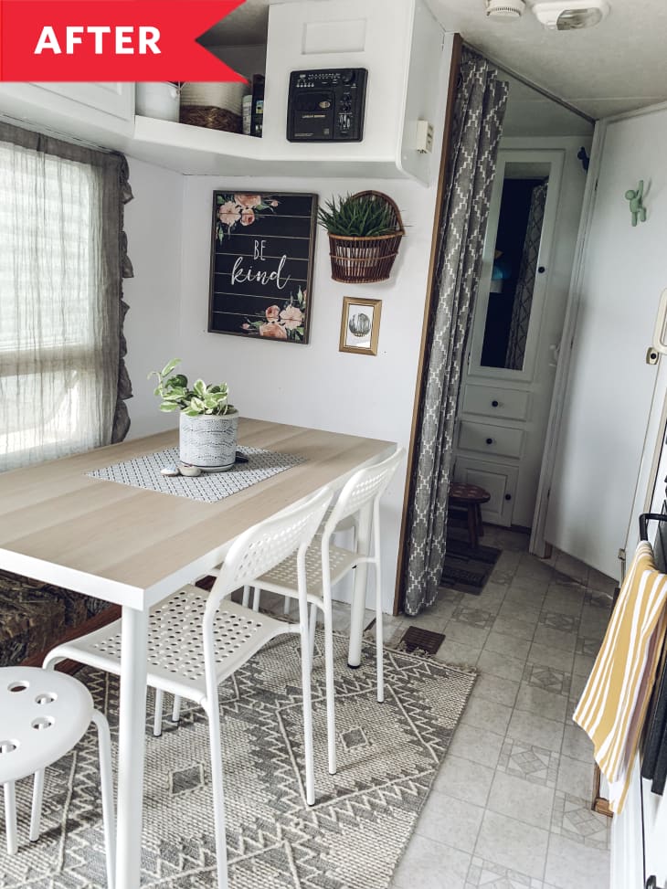 After: RV Dining area with white walls, white table and chairs, and decor on wall
