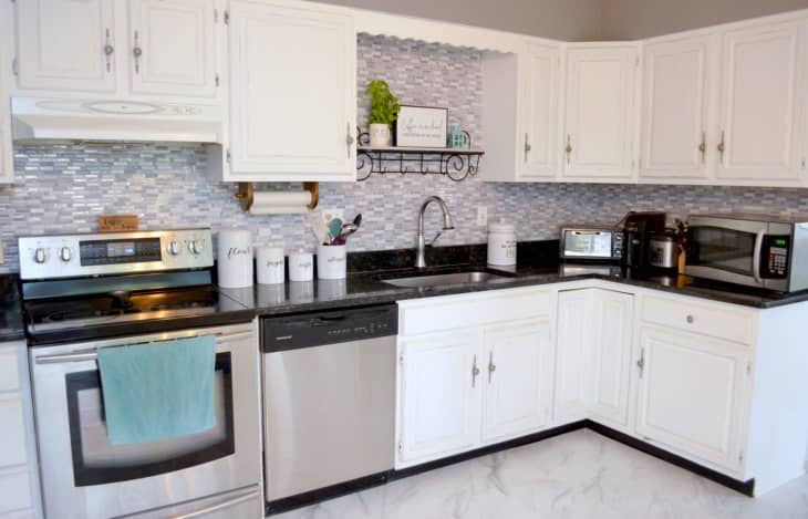 Kitchen with stick-on backsplash in gray and white mosaic pattern.