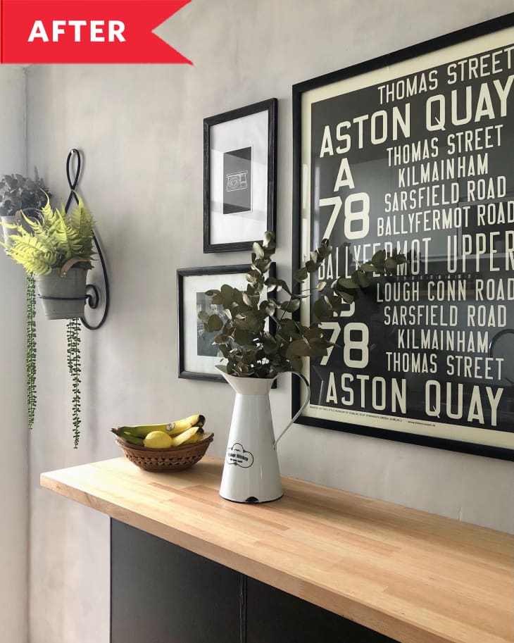 After: Black and white print with street names hanging on cement wall above counter
