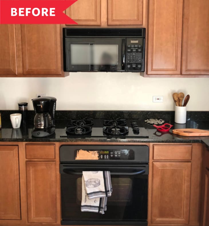 Before: Black oven, range, and microwave surrounded by dark wood cabinets
