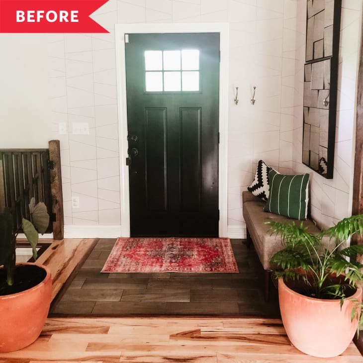Before: Interior entryway with white walls and black door