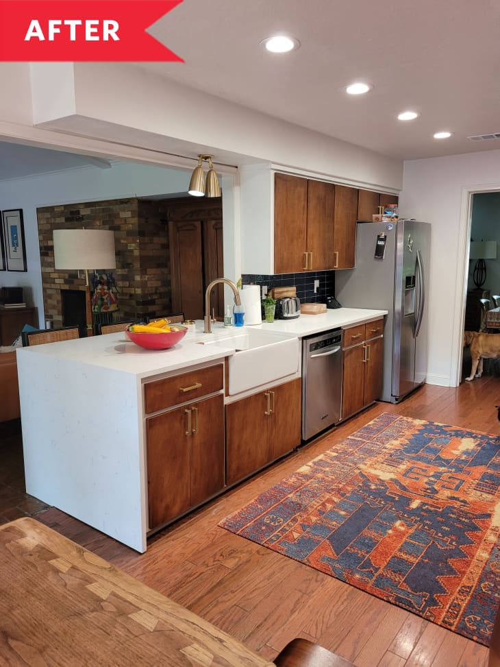 After: Warm, modern kitchen with sleek cabinetry and colorful rug in center