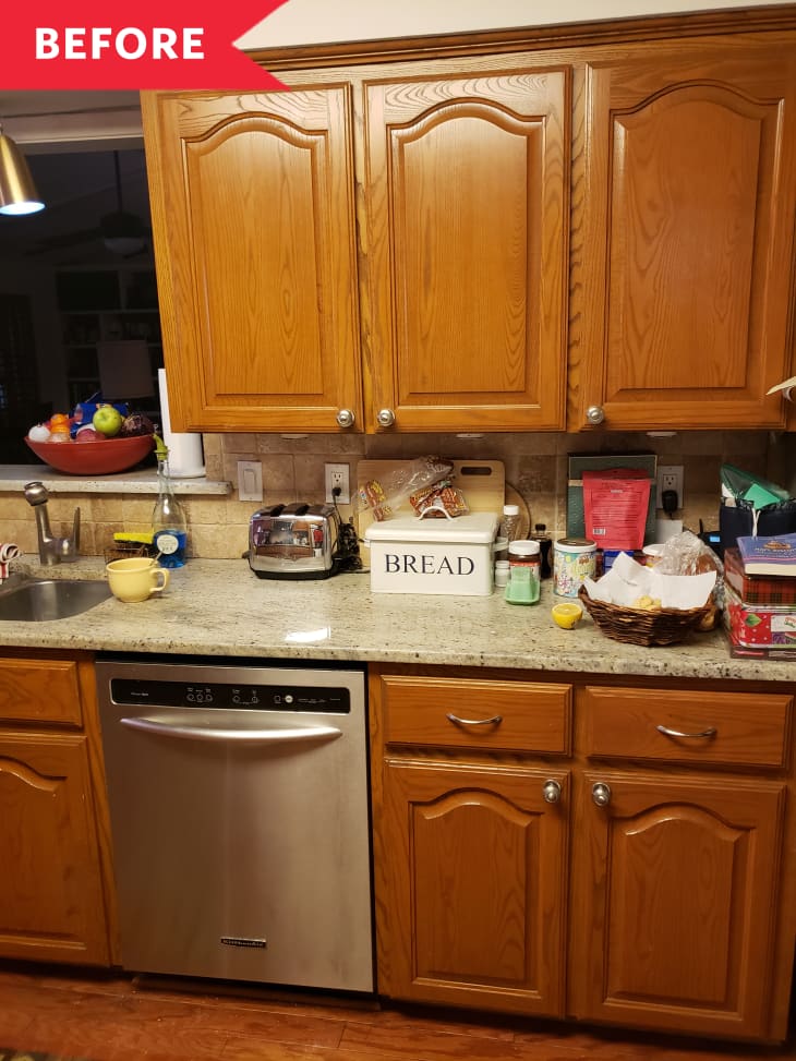 Before: Dated cabinets and cluttered countertops in kitchen
