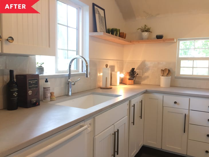 After: Sink with silver faucet beneath window in bright white kitchen
