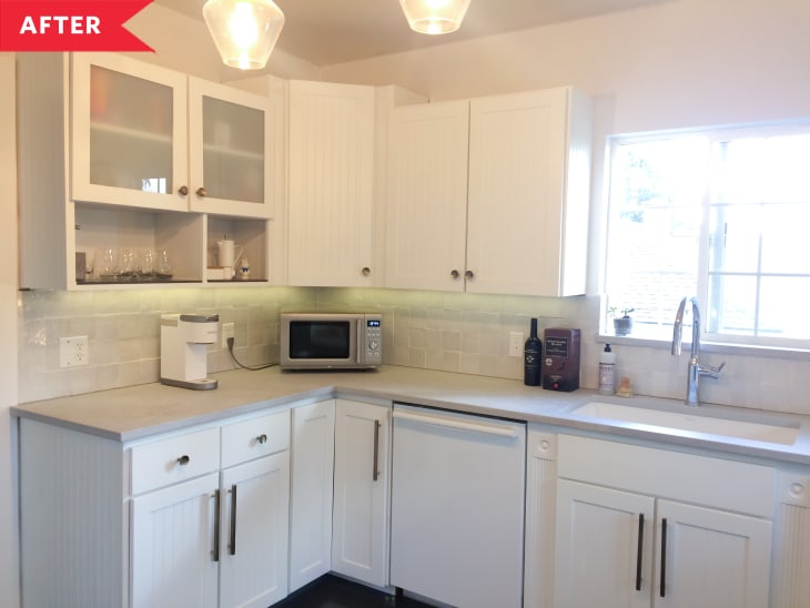 After: Kitchen with white cabinets, white walls, and white stacked tile backsplash