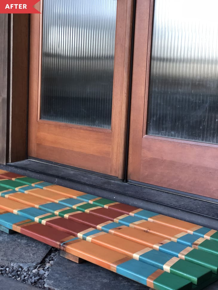 After: wood doormat painted with blue, orange, green, and red triangles