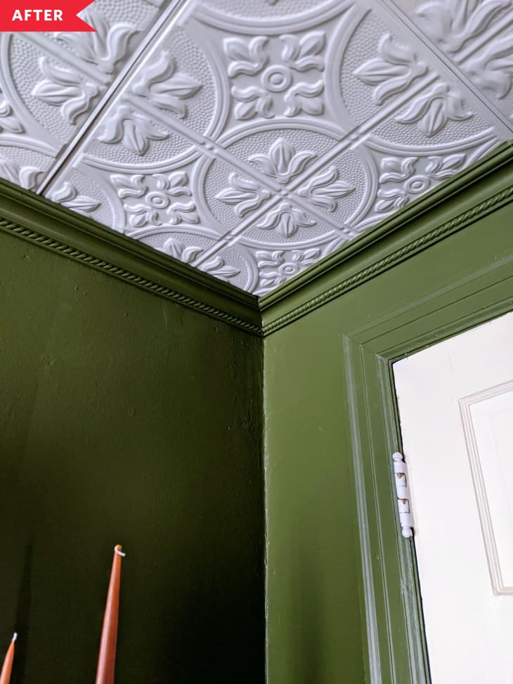 After: Close-up of tin tile ceiling and crown molding in green bedroom
