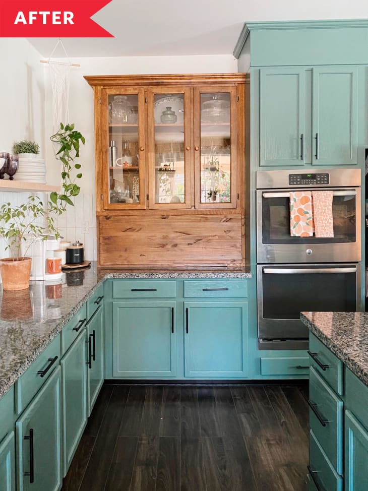 Teal kitchen cabinets with dark wood floors