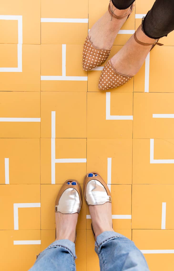 tiled floor painted yellow with white irregular geometric pattern
