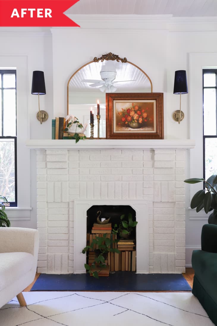 After: White brick fireplace with mirror and floral artwork on top and books in firebox