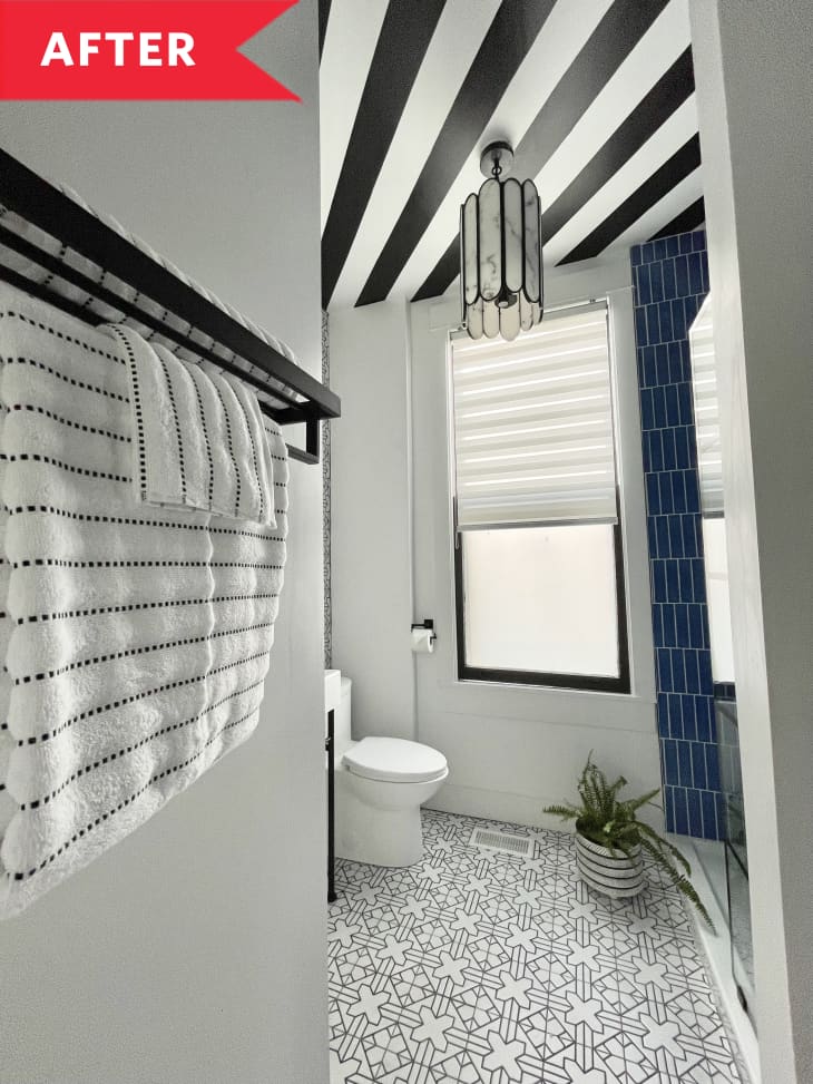 After: Black and white bathroom with tiled wall and floor plus bold striped ceiling