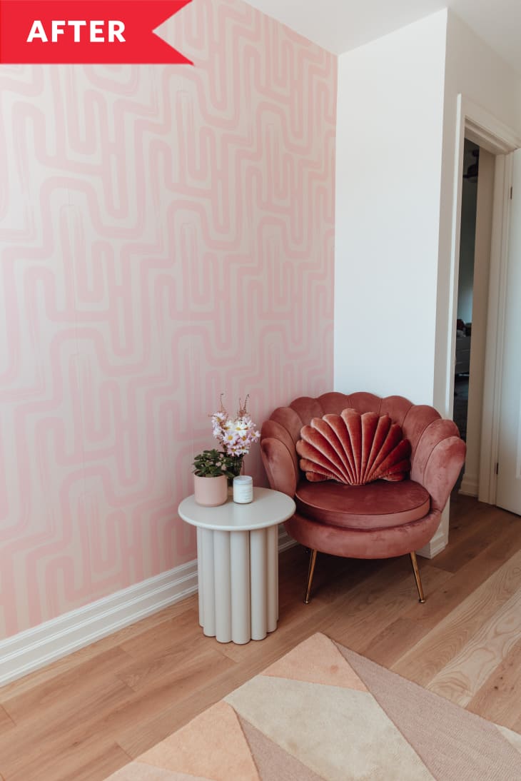 After: Salmon-colored velvet fan chair next to fluted accent table and wall with pink squiggly wallpaper