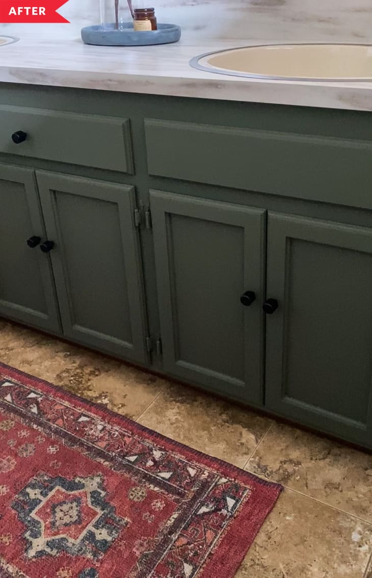 After: Close-up of painted green vanity with black knobs