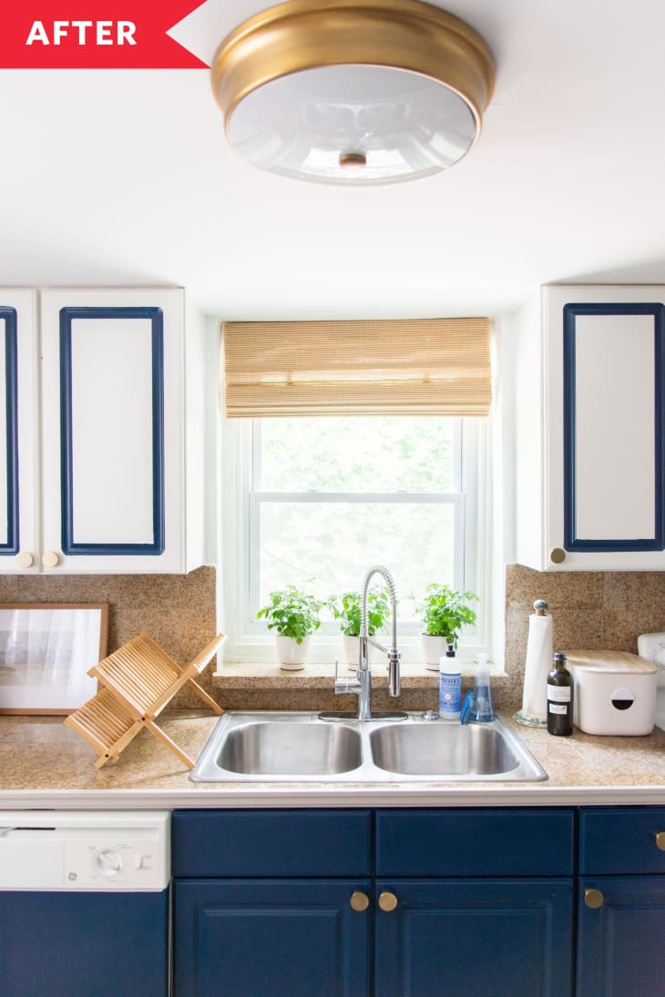 kitchen white walls blue cabinets gold light fixture