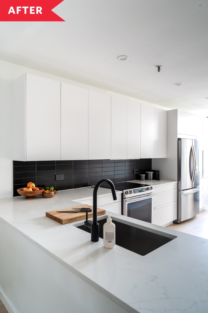 white cabinets black backsplash white counters