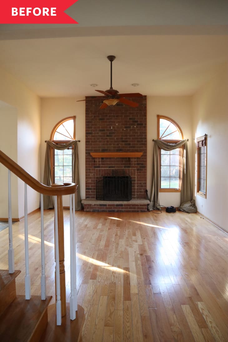 empty living room before renovation brick fireplace