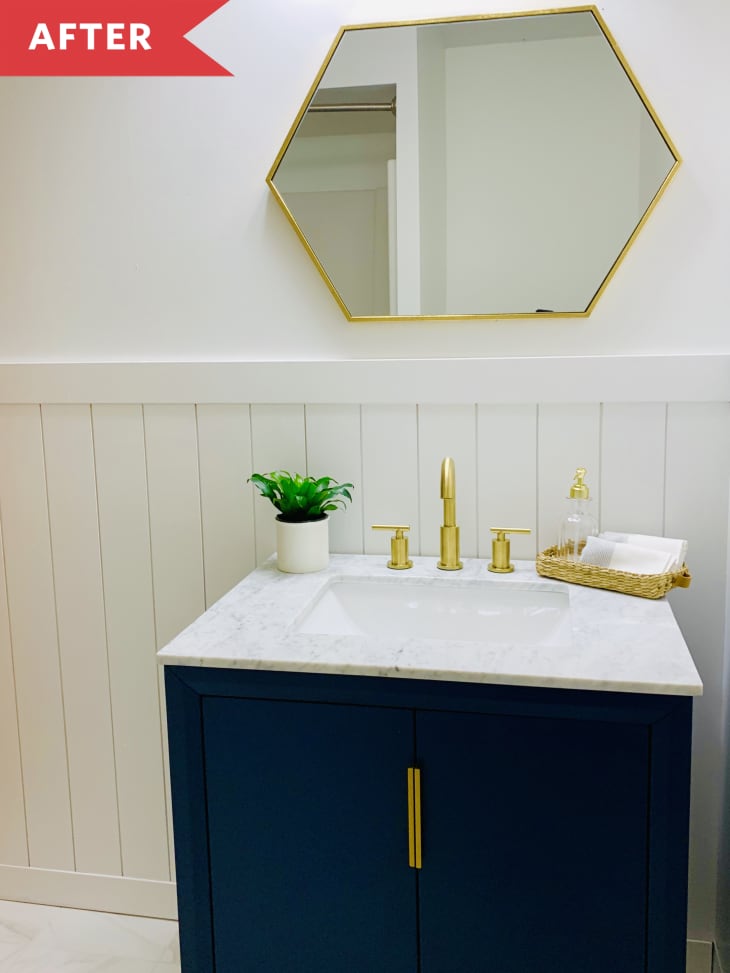 white paneled walls gold mirror blue vanity