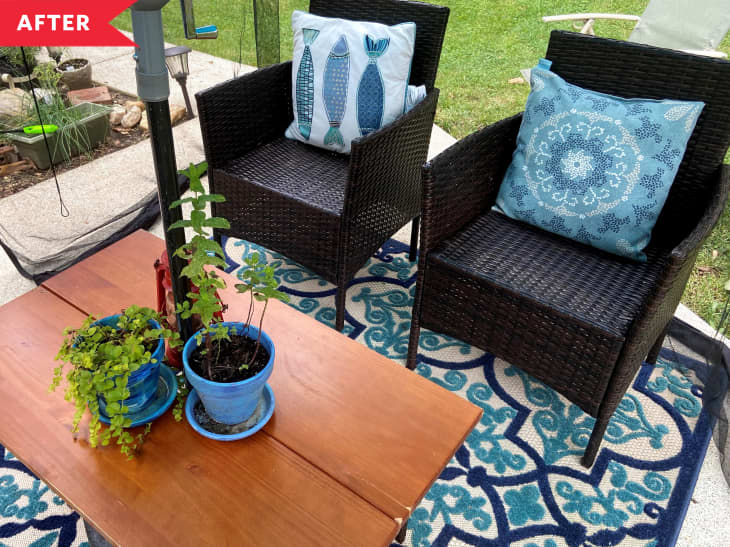 After: Brown wcker lounge cairs with blue accent pillows on patio with blue rug