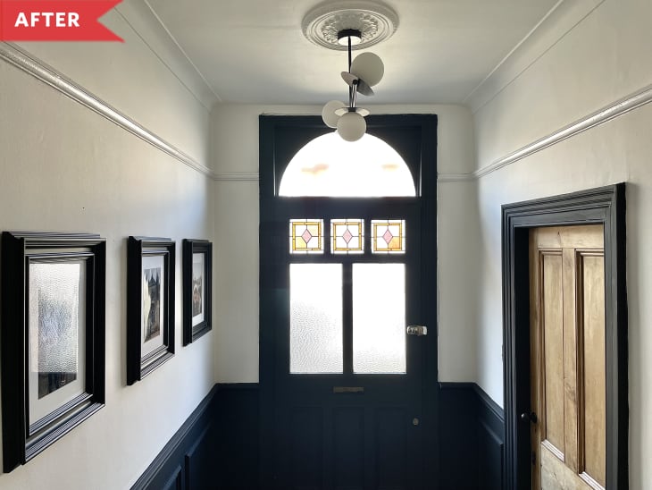 After: Black front door with stained glass in entryway with trim and moulding painted black