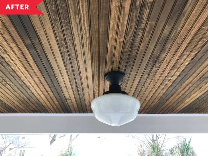 Tongue and groove wooden ceiling white light fixture