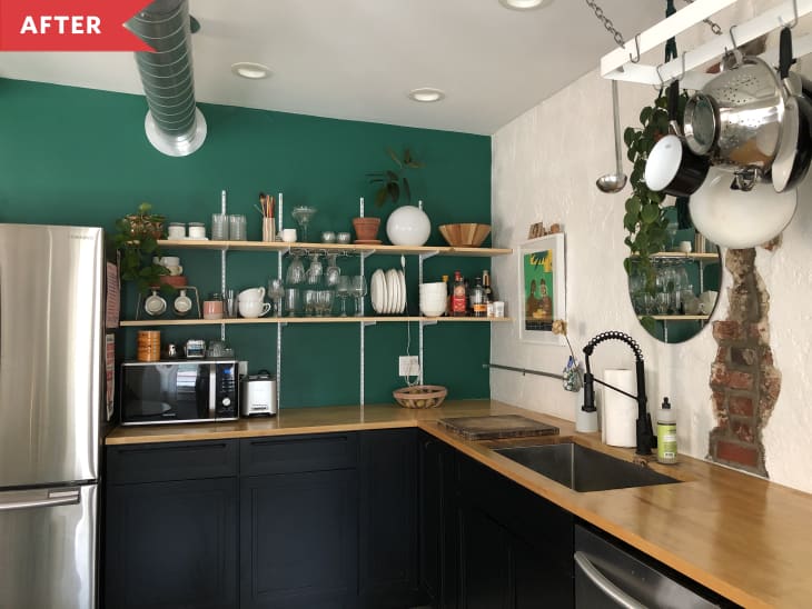 After: Corner of kitchen with green accent wall and open shelving