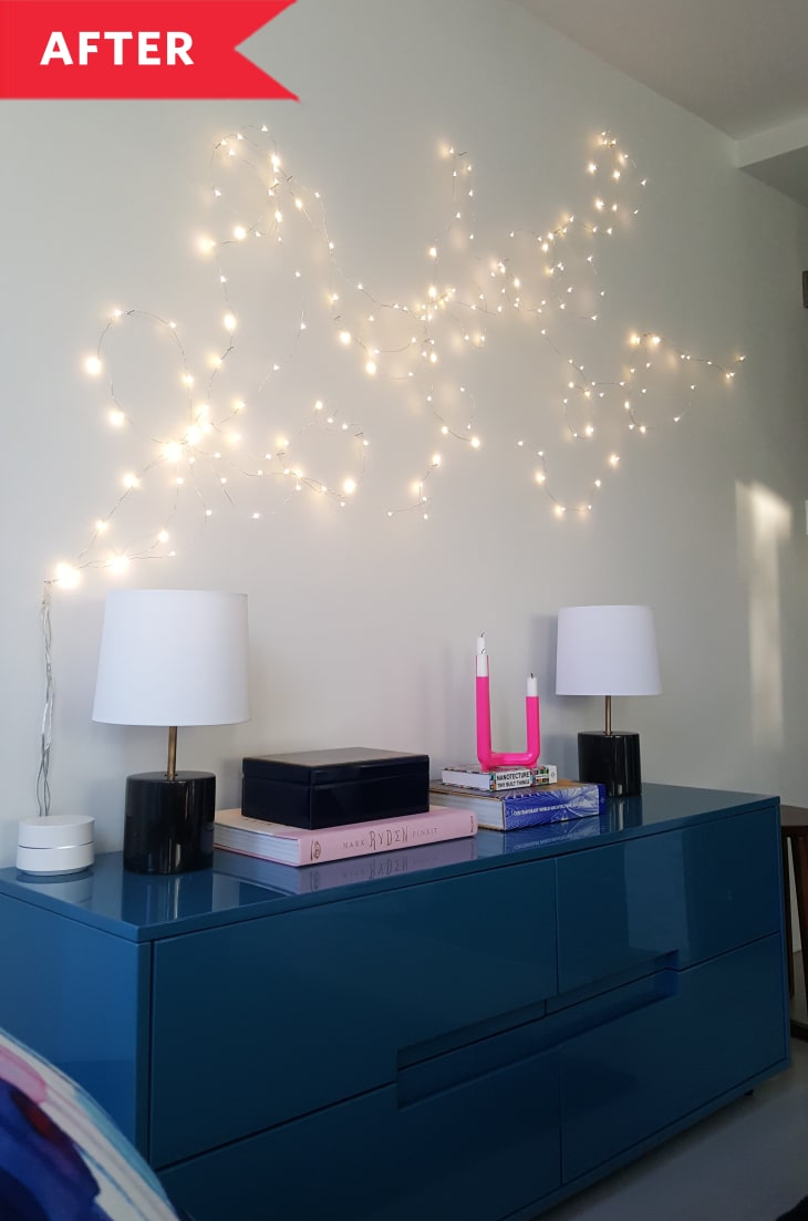 After: String light wall art above blue credenza in living room