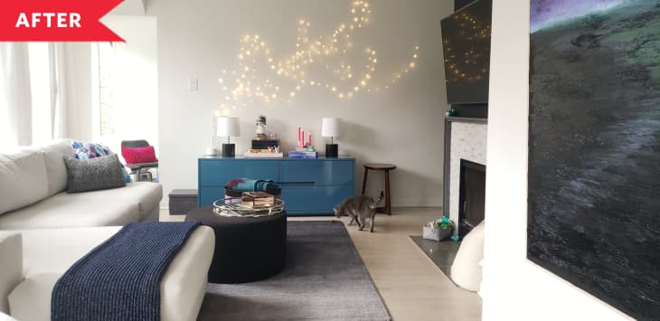 After: Bright living room with white sectional, blue credenza, and string light wall art
