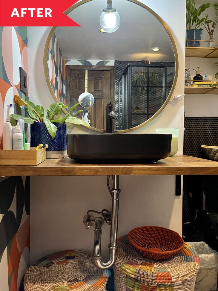 After: Sink on wooden countertop with circular mirror above