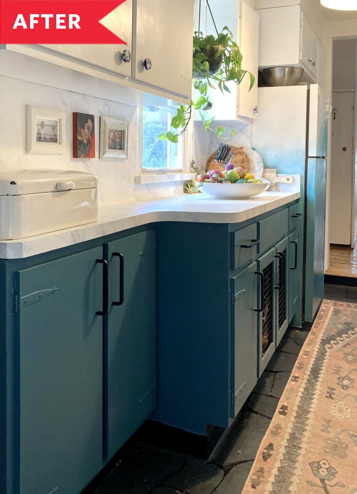 After: Kitchen with teal lower cabinets, stainless steel range, and vintage-looking runner