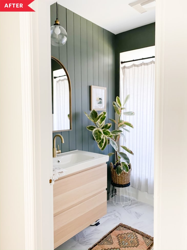 After: Bathroom with green walls, wood vanity, and tile floors