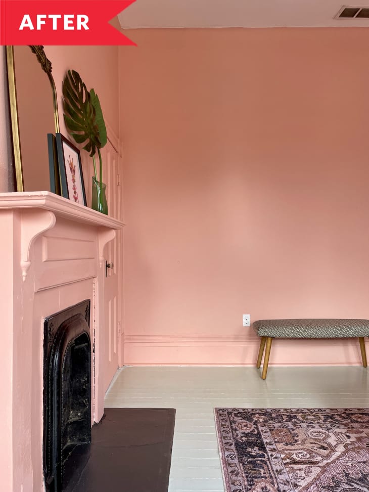 Bench in room with pink walls and pink fireplace