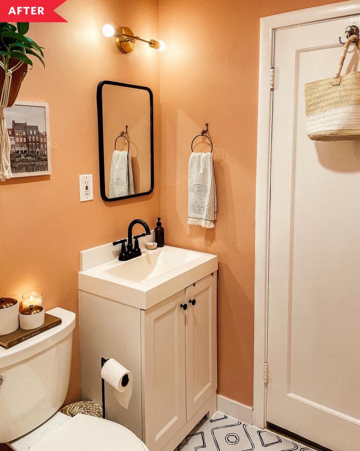 After: Bathroom with a warm orange wall color, black and white patterned floors, and a white vanity