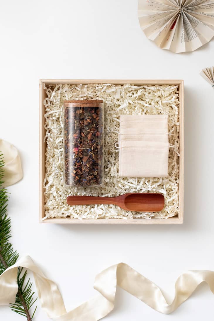 gift box with a jar of loose leaf tea and a scoop