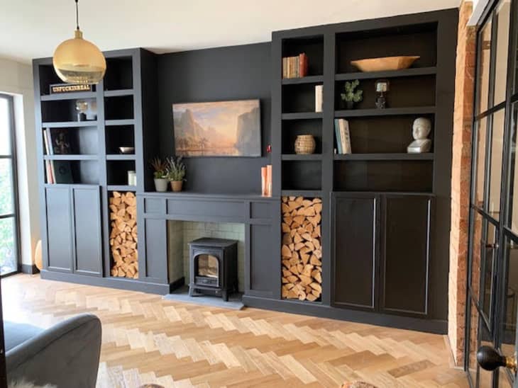 Fireplace wall with black built-ins made from BILLY bookcases