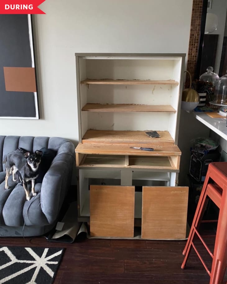 During: gray painted vintage hutch during paint stripping process, with some shelves natural wood