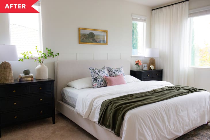 After: Cream-painted bedroom with board and batten walls, upholstered bed, and black nightstands