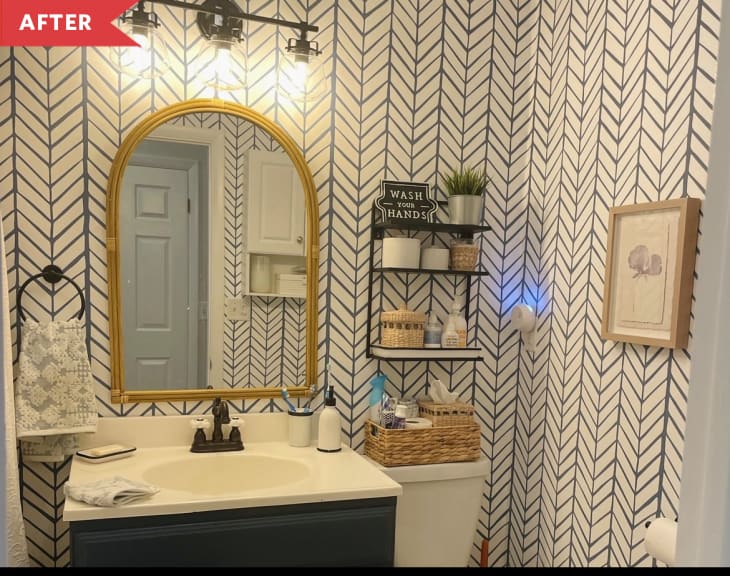 After: Bathroom with arched mirror, chevron wallpaper, and shelf above toilet